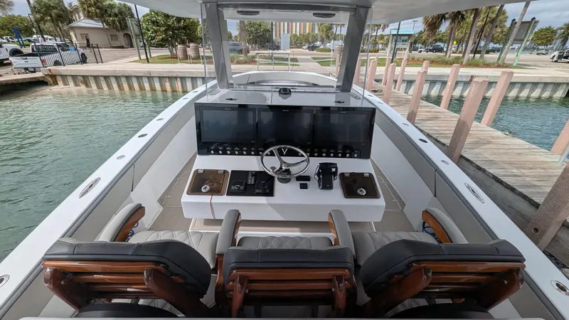  Yacht Photos Pics 2021 Vela 368 Center Console boat with modern helm and seating, docked by the water.