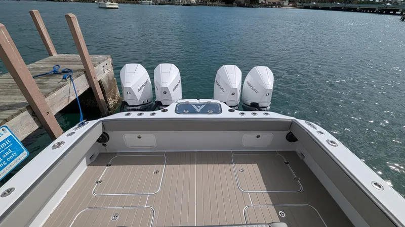  Yacht Photos Pics 2021 Vela 368 Center Console boat with four engines docked by the water.