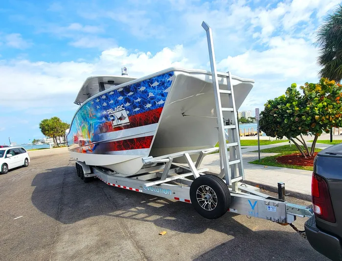  Yacht Photos Pics 2021 Vela 368 Center Console boat on trailer with vibrant patriotic design.