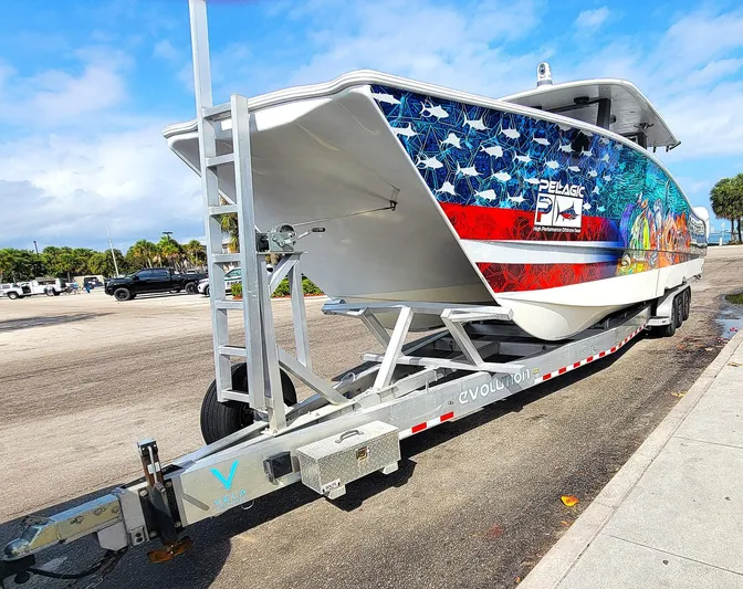  Yacht Photos Pics 2021 Vela 368 Center Console boat with American flag design on trailer.