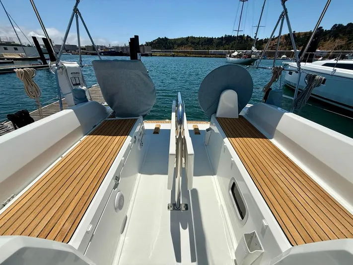 Fasttack Yacht Photos Pics 2024 Beneteau Oceanis 30.1 sailboat cockpit with wooden seating, docked in a marina.