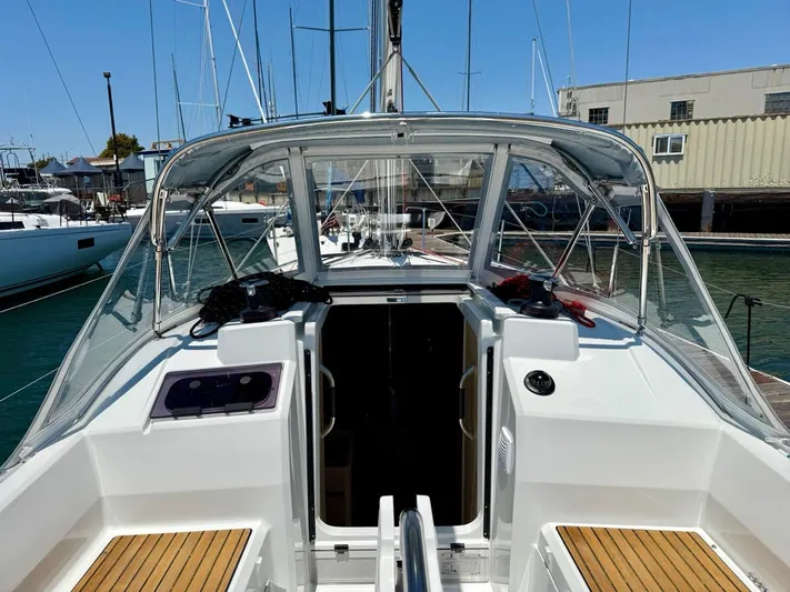 Fasttack Yacht Photos Pics 2024 Beneteau Oceanis 30.1 sailboat cockpit with clear canopy and wooden seating.