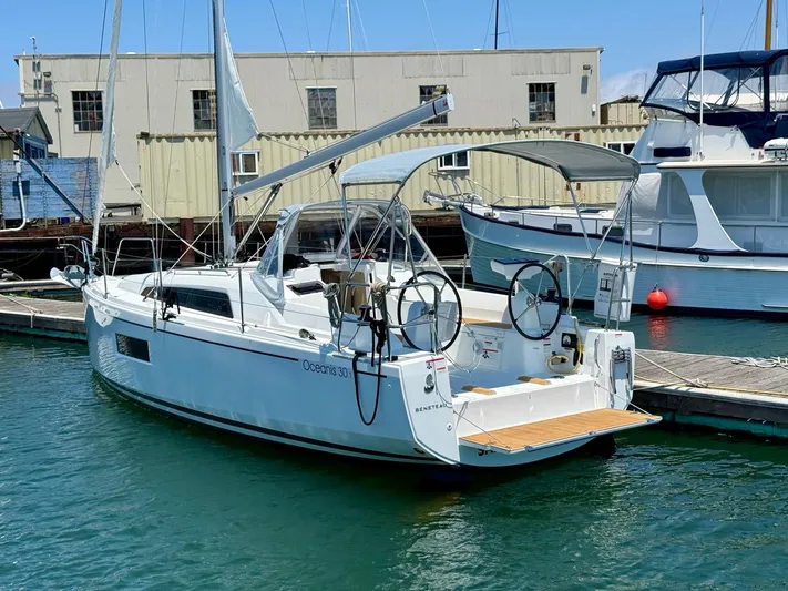 Fasttack Yacht Photos Pics 2024 Beneteau Oceanis 30.1 sailboat docked in marina, featuring dual steering wheels.