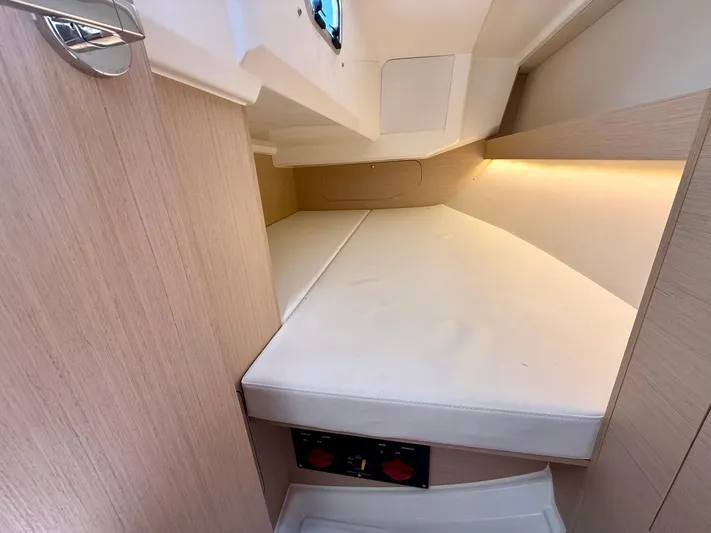 Fasttack Yacht Photos Pics Cozy cabin interior of 2024 Beneteau Oceanis 30.1 sailboat with soft lighting.