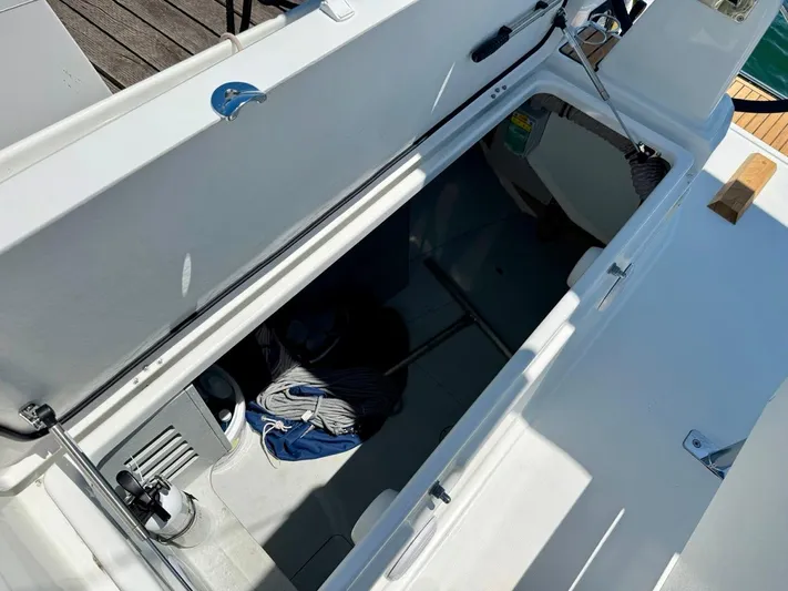 Fasttack Yacht Photos Pics 2024 Beneteau Oceanis 30.1 sailboat storage compartment with open hatch, dockside view.