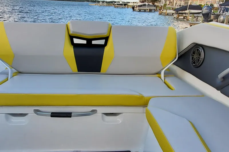  Yacht Photos Pics 2024 Scarab 285 Wake ID boat interior with yellow and gray seating by the water.
