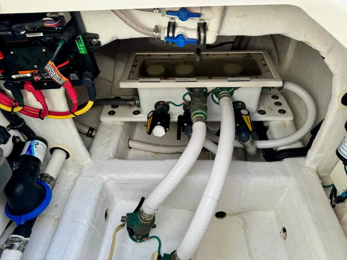 Lulu Yacht Photos Pics Engine compartment of 2020 Invincible 35 Catamaran with visible wiring and hoses.