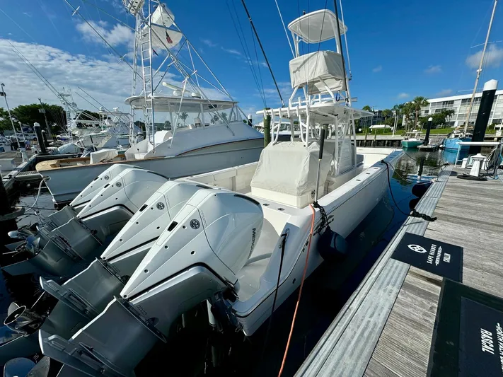 Lulu Yacht Photos Pics 2020 Invincible 35 Catamaran docked with triple outboard engines.