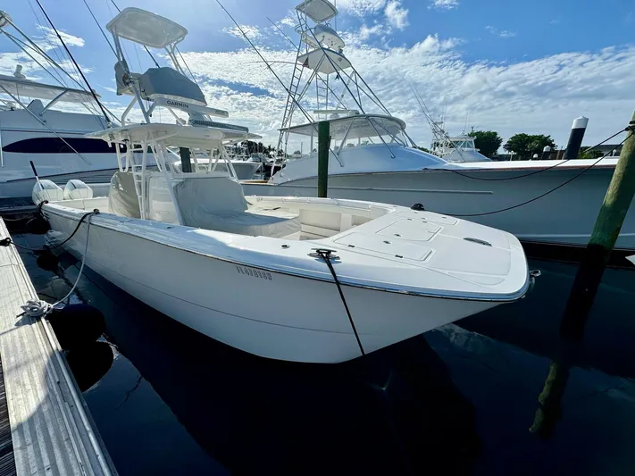 Lulu Yacht Photos Pics 2020 Invincible 35 Catamaran docked, sleek white design, clear sky background.