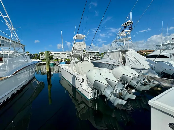 Lulu Yacht Photos Pics 2020 Invincible 35 Catamaran docked at marina under clear blue sky.