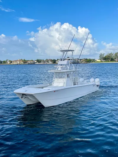 Lulu Yacht Photos Pics 2020 Invincible 35 Catamaran on calm water under blue sky.