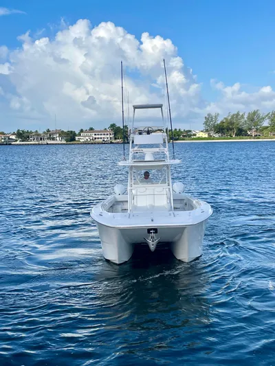 Lulu Yacht Photos Pics 2020 Invincible 35 Catamaran on calm water under a clear blue sky.