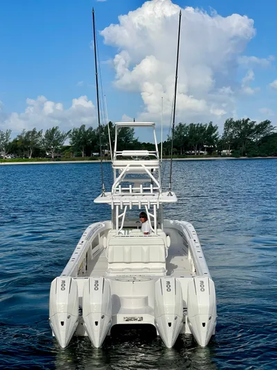 Lulu Yacht Photos Pics 2020 Invincible 35 Catamaran on water, featuring multiple outboard engines.