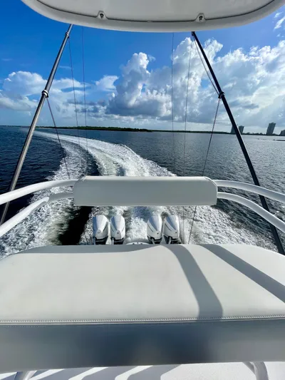 Lulu Yacht Photos Pics 2020 Invincible 35 Catamaran cruising on open water under a clear blue sky.
