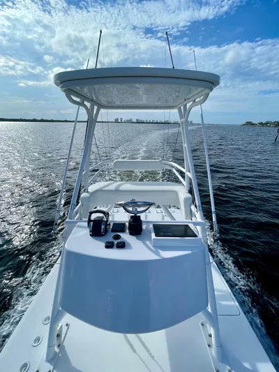 Lulu Yacht Photos Pics 2020 Invincible 35 Catamaran cruising on open water under a clear blue sky.