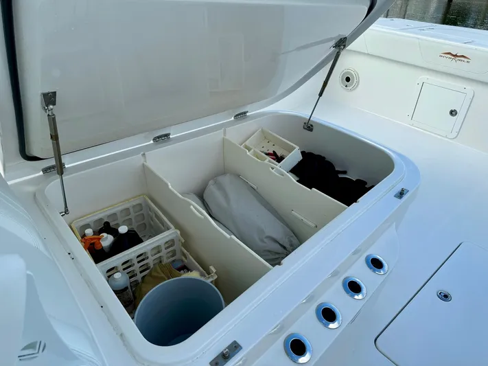 Lulu Yacht Photos Pics Open storage compartment on 2020 Invincible 35 Catamaran, organized with various items.