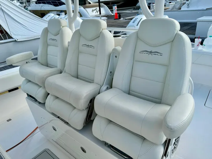 Lulu Yacht Photos Pics Luxurious seating on 2020 Invincible 35 Catamaran, featuring plush white leather chairs.