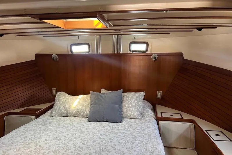 Rhiannon Yacht Photos Pics Cozy cabin interior of 1987 Kadey-Krogen Manatee 36 with wooden accents and bedding.