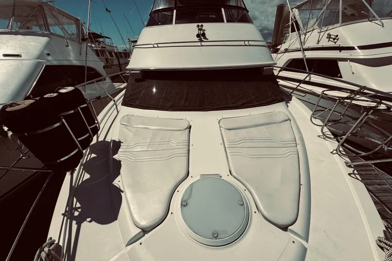 Tom’s Cruise Yacht Photos Pics 2005 Carver 466 Motor Yacht docked, showcasing sleek design and spacious deck.