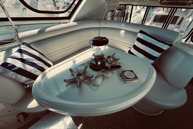 Tom’s Cruise Yacht Photos Pics Luxurious interior of 2005 Carver 466 Motor Yacht with striped pillows and nautical decor.