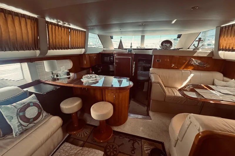 Tom’s Cruise Yacht Photos Pics Luxurious interior of 2005 Carver 466 Motor Yacht with elegant seating and wooden finishes.