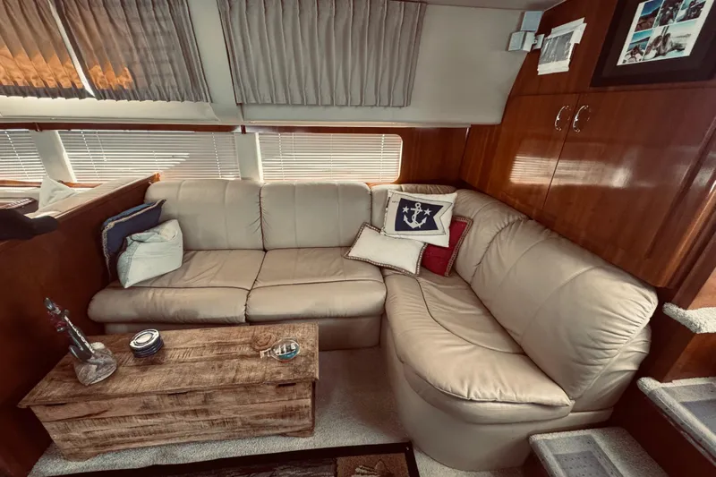 Tom’s Cruise Yacht Photos Pics Luxurious interior of 2005 Carver 466 Motor Yacht with beige leather sofa and nautical decor.