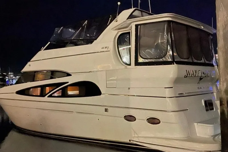 Tom’s Cruise Yacht Photos Pics 2005 Carver 466 Motor Yacht docked at night, featuring sleek design and spacious cabin.