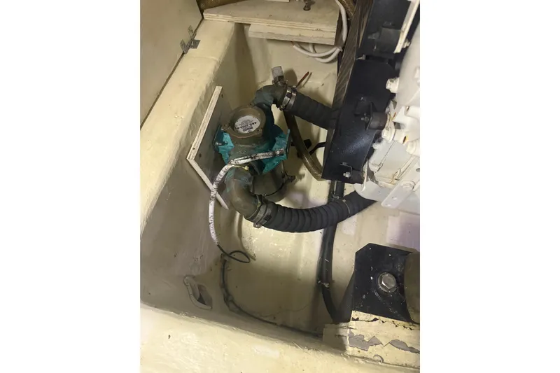 Tom’s Cruise Yacht Photos Pics Engine compartment of 2005 Carver 466 Motor Yacht, featuring hoses and mechanical components.