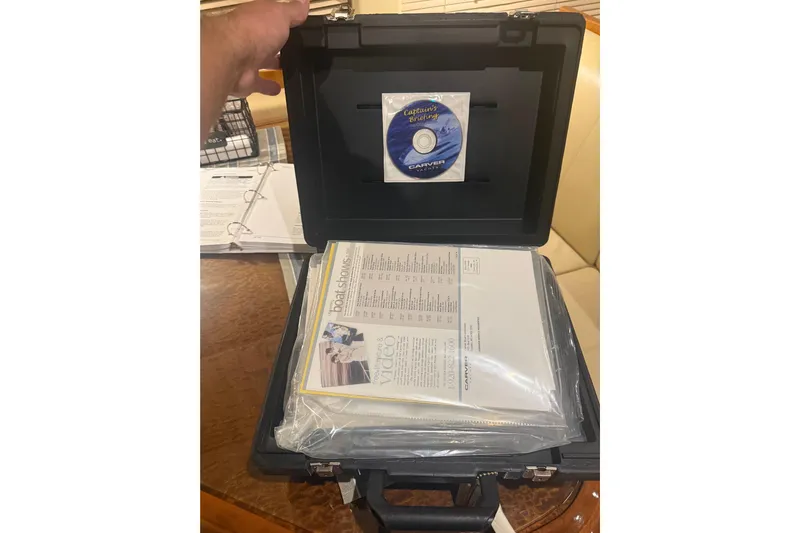 Tom’s Cruise Yacht Photos Pics Open case with Carver 466 Motor Yacht documents and CD, 2005 model.