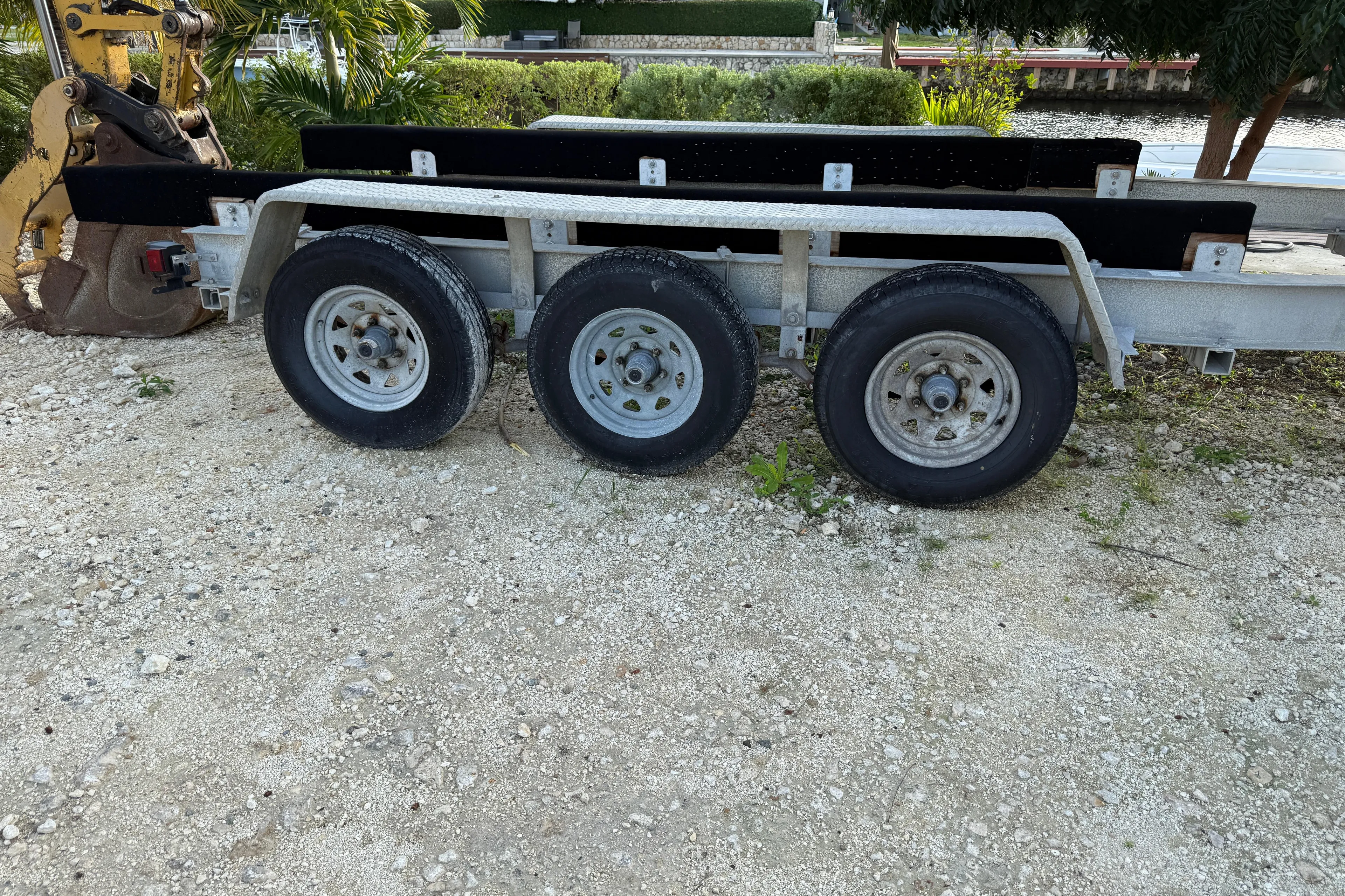 Overdraft Yacht Photos Pics Triple-axle boat trailer on gravel, suitable for 2005 Boston Whaler 320 Outrage.