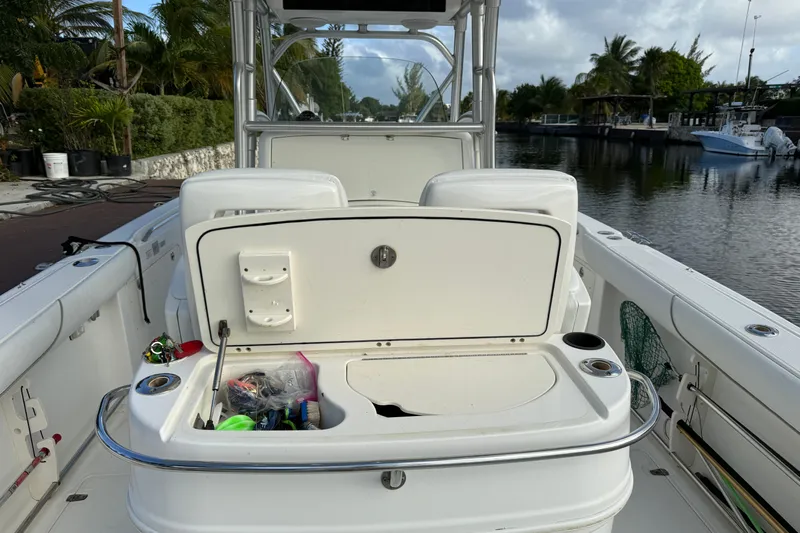 Overdraft Yacht Photos Pics 2005 Boston Whaler 320 Outrage boat interior with open storage compartment by the water.