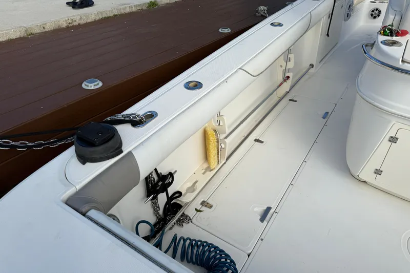 Overdraft Yacht Photos Pics 2005 Boston Whaler 320 Outrage boat deck with storage compartments and equipment.
