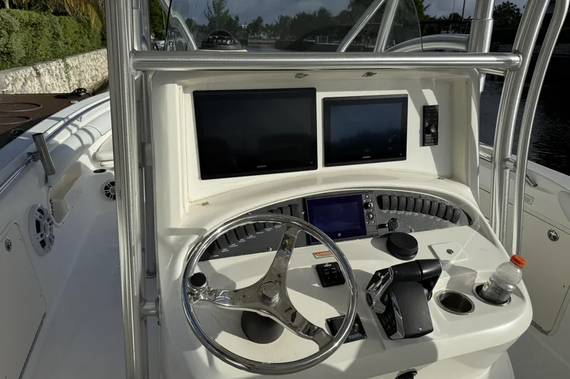Overdraft Yacht Photos Pics 2005 Boston Whaler 320 Outrage helm with dual screens and steering wheel.