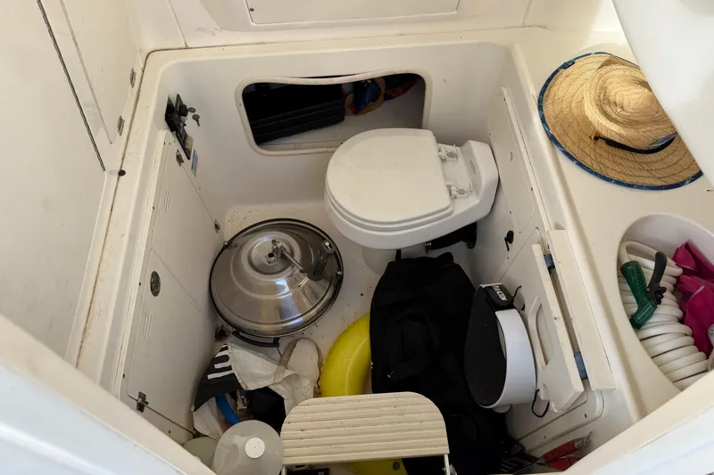 Overdraft Yacht Photos Pics Interior of a 2005 Boston Whaler 320 Outrage boat with toilet and storage items.