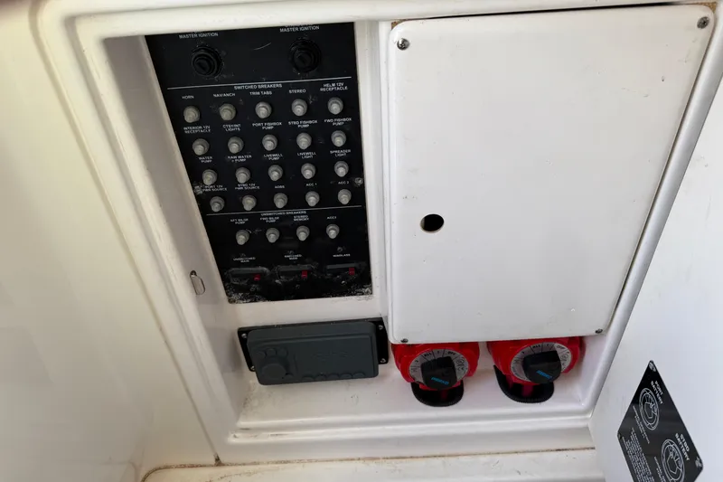 Overdraft Yacht Photos Pics Electrical panel of a 2005 Boston Whaler 320 Outrage boat, featuring switches and controls.