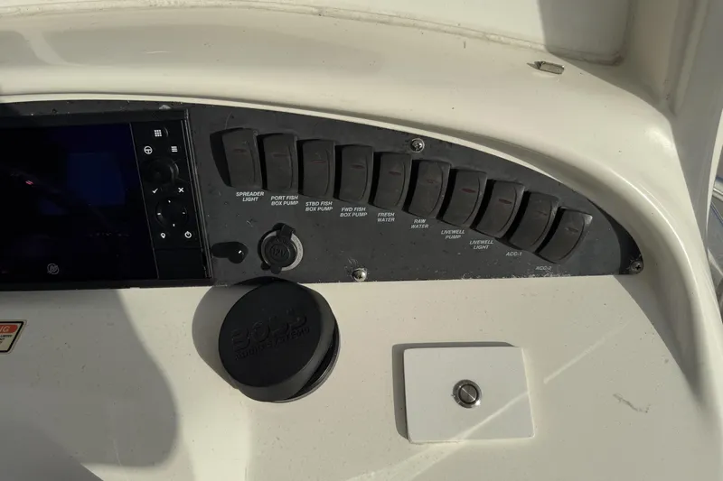 Overdraft Yacht Photos Pics Control panel of a 2005 Boston Whaler 320 Outrage boat with labeled switches.