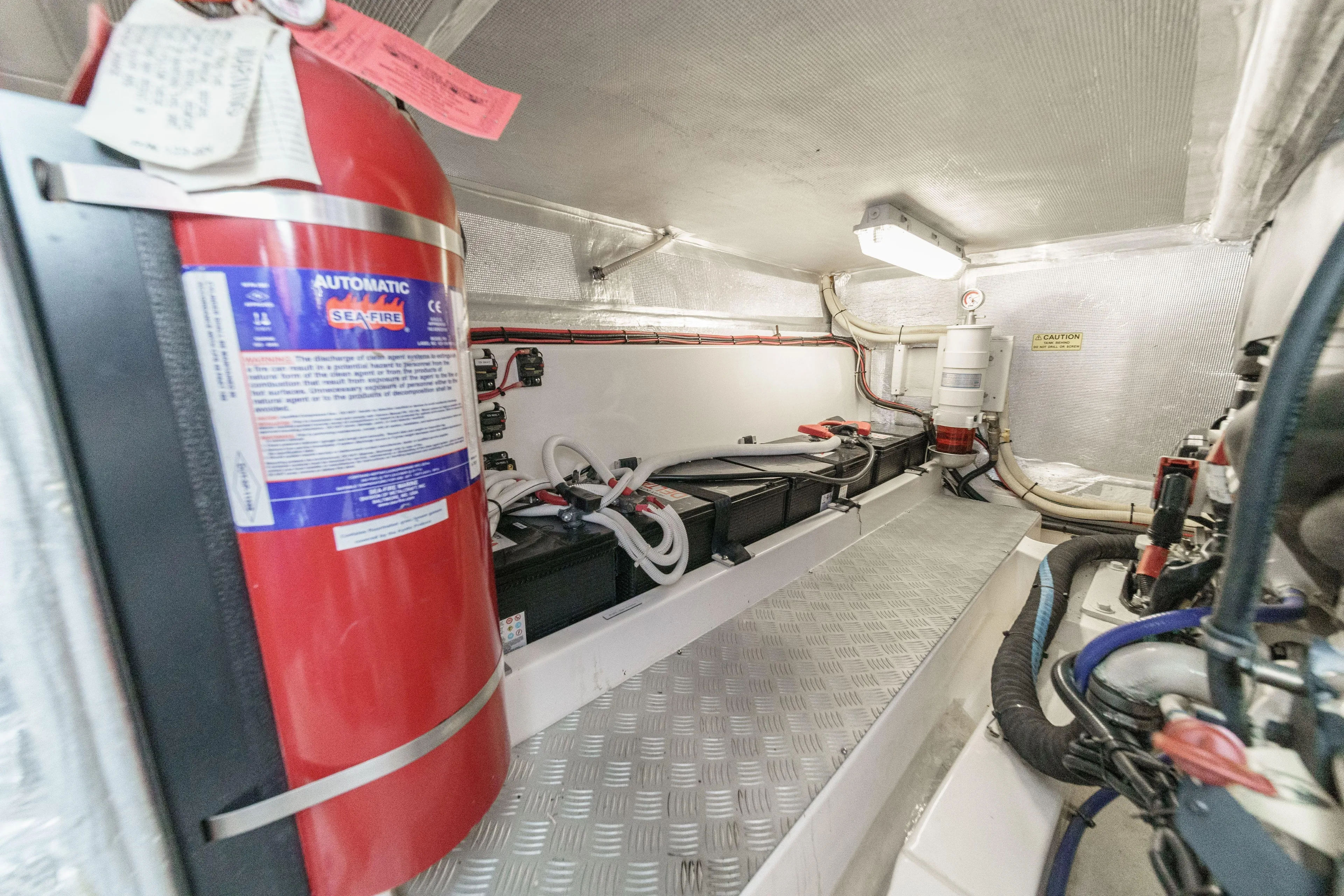 Reel Rodeo Yacht Photos Pics Engine room of 2014 Maritimo 470 Offshore Convertible with fire extinguisher and equipment.