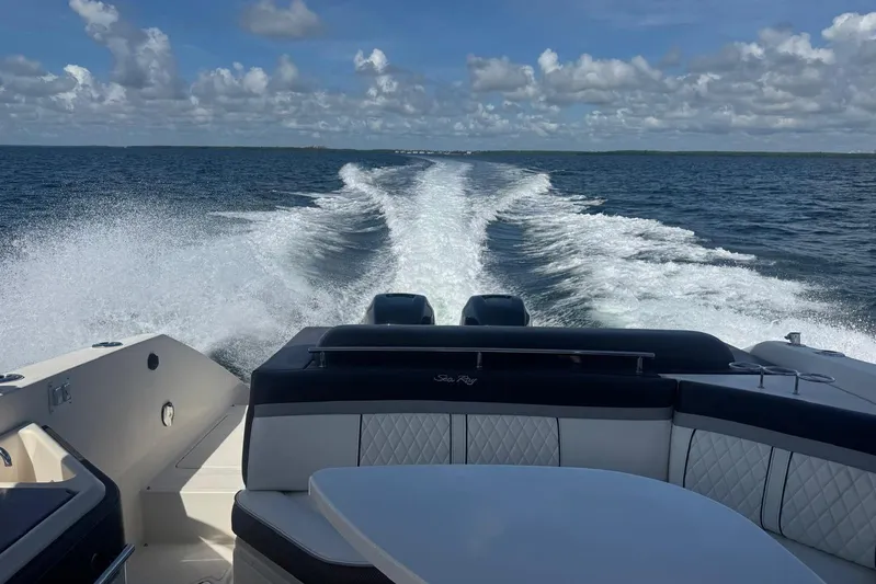  Yacht Photos Pics 2017 Sea Ray SLX 310 Outboard cruising on open water, leaving a wake behind.