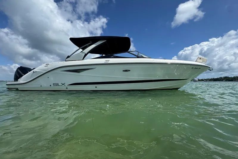  Yacht Photos Pics 2017 Sea Ray SLX 310 Outboard boat on calm water under a partly cloudy sky.