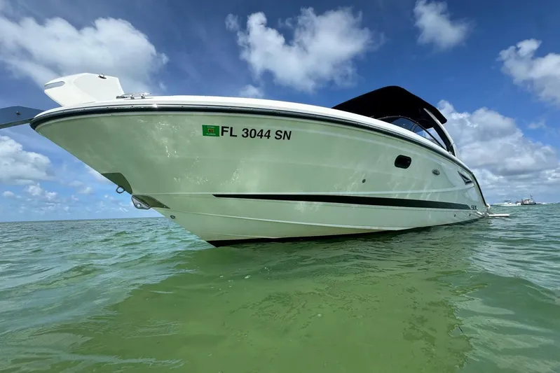  Yacht Photos Pics 2017 Sea Ray SLX 310 Outboard boat on calm water under blue sky.