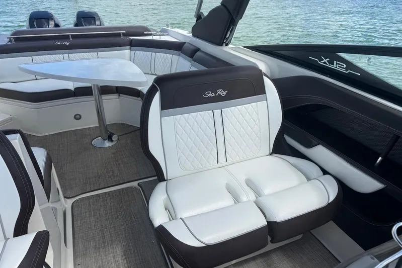  Yacht Photos Pics Luxurious interior of 2017 Sea Ray SLX 310 Outboard with elegant seating and table.