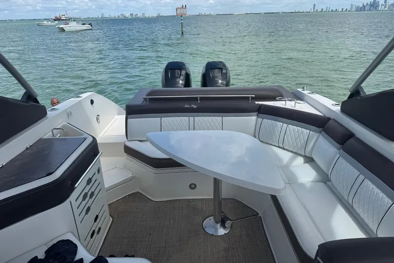  Yacht Photos Pics 2017 Sea Ray SLX 310 Outboard boat interior with seating and table on the water.