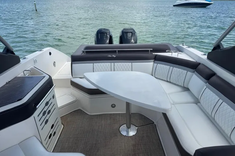  Yacht Photos Pics 2017 Sea Ray SLX 310 Outboard interior with seating and table on calm water.
