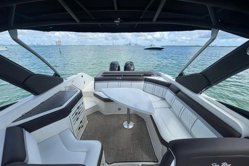  Yacht Photos Pics 2017 Sea Ray SLX 310 Outboard boat interior with seating, table, and ocean view.