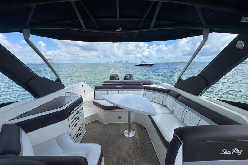  Yacht Photos Pics 2017 Sea Ray SLX 310 Outboard boat interior with seating, table, and ocean view.
