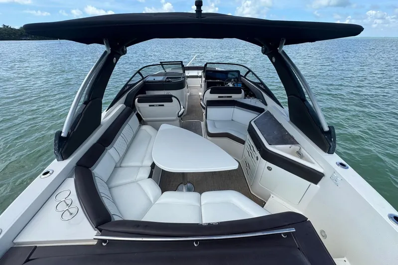  Yacht Photos Pics 2017 Sea Ray SLX 310 Outboard boat interior with seating and table on calm water.