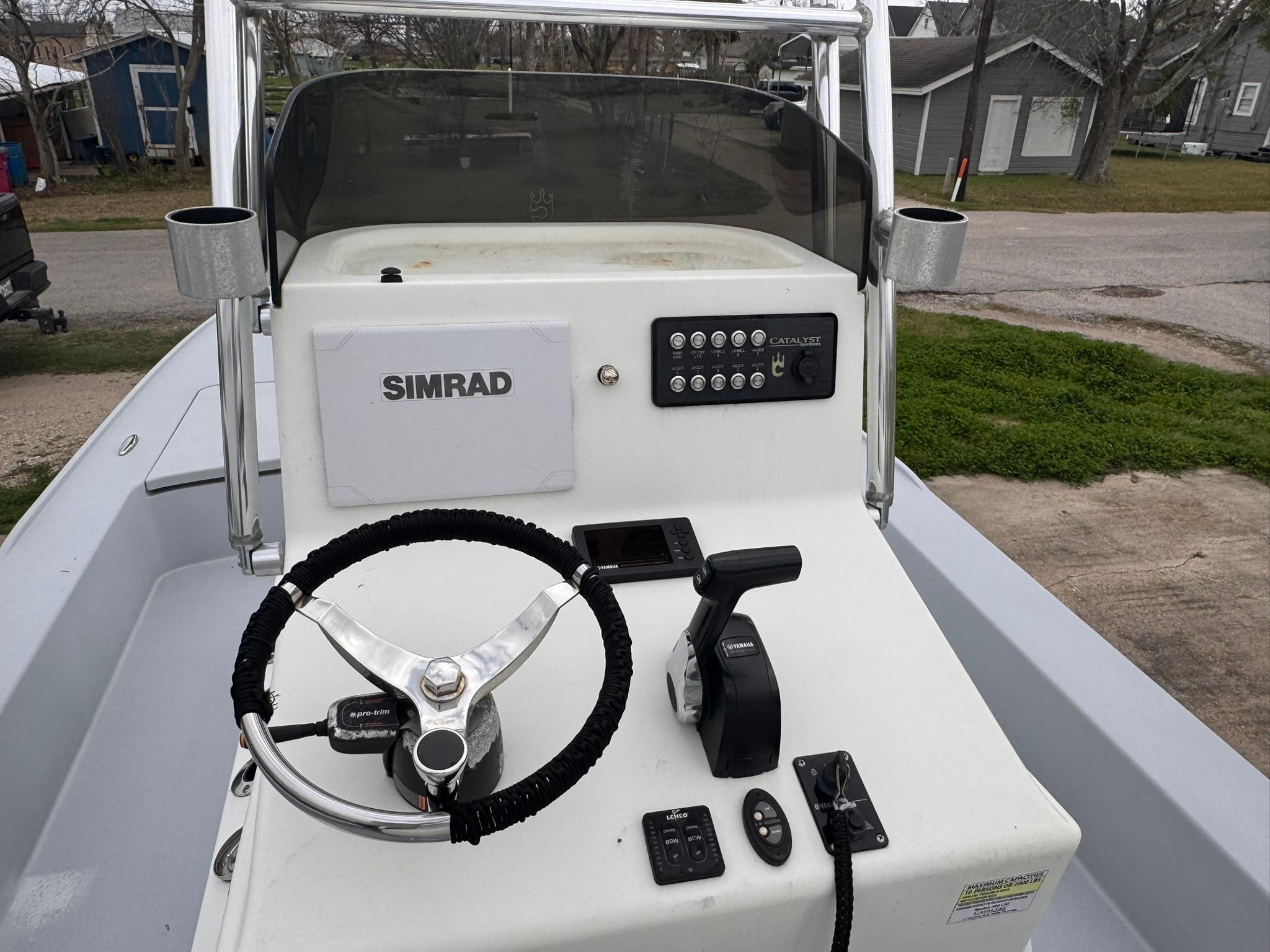 2019 Catalyst 260 Catamaran helm with Simrad electronics and steering wheel.