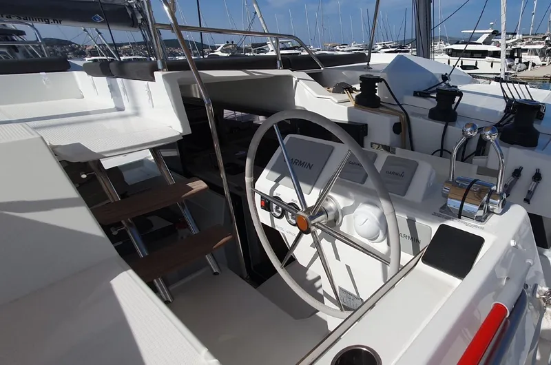  Yacht Photos Pics 2024 Fountaine Pajot Catamaran Elba 45 helm with steering wheel and navigation controls.