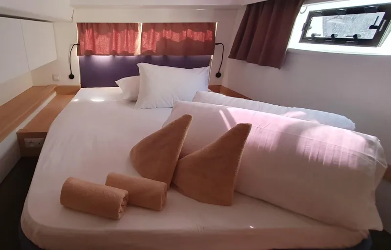  Yacht Photos Pics Luxurious bedroom interior of 2024 Fountaine Pajot Catamaran Elba 45 with cozy bedding.