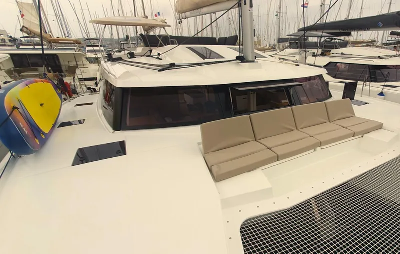  Yacht Photos Pics 2024 Fountaine Pajot Catamaran Elba 45 with spacious deck and seating area in marina.